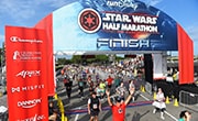 Runners cross the finish line of the Star Wars Dark Side Half Marathon at Walt Disney World.